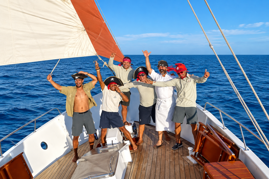 Guests enjoying the outdoor deck of a mid-range Galápagos cruise sailing through the Pacific Ocean